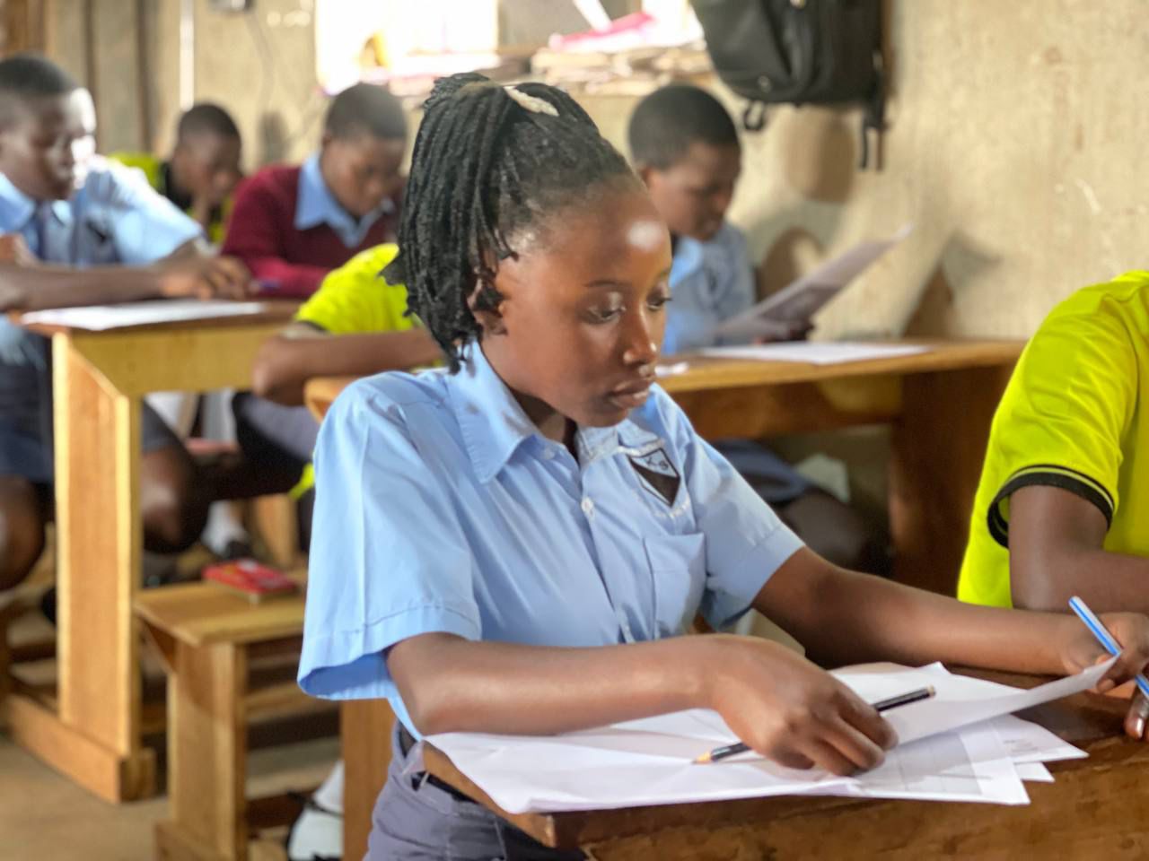 A KUP student studying at her desk in class